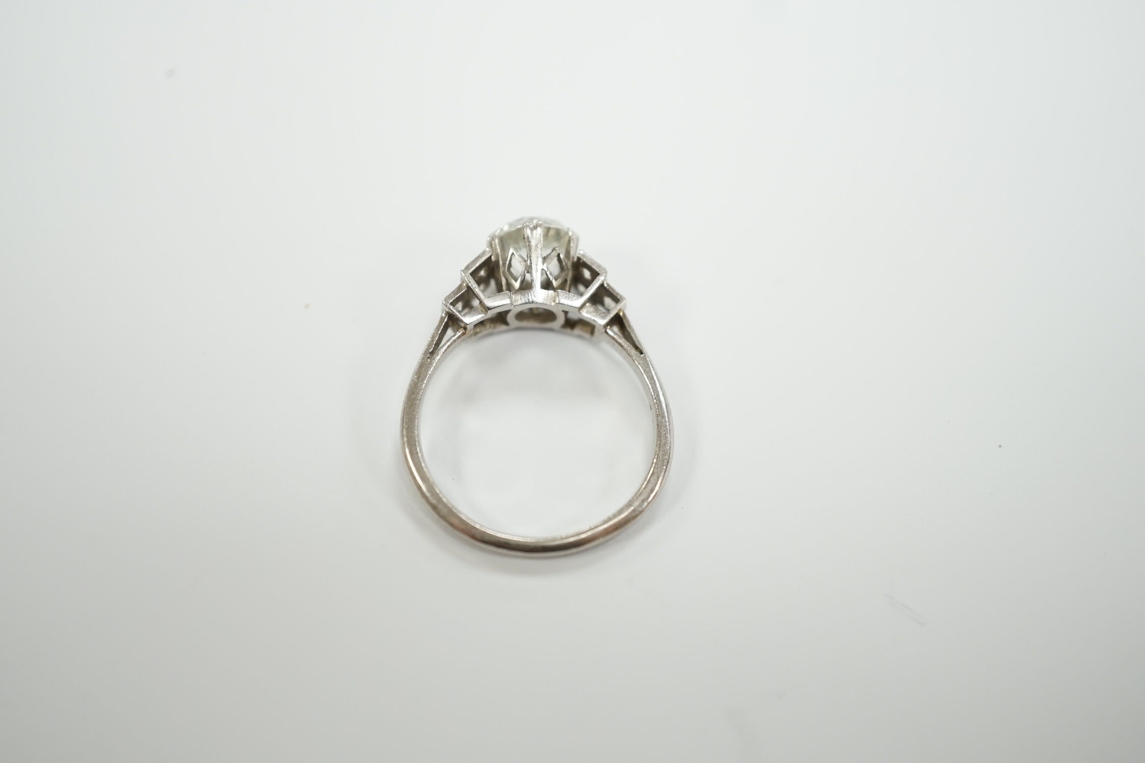 A mid 20th century white metal (stamped plat) and single stone white zircon? set ring, with simulated diamond set shoulders, size N, gross weight 4.3 grams.